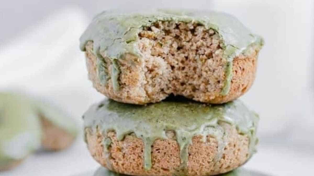 A stack of donuts with green frosting.