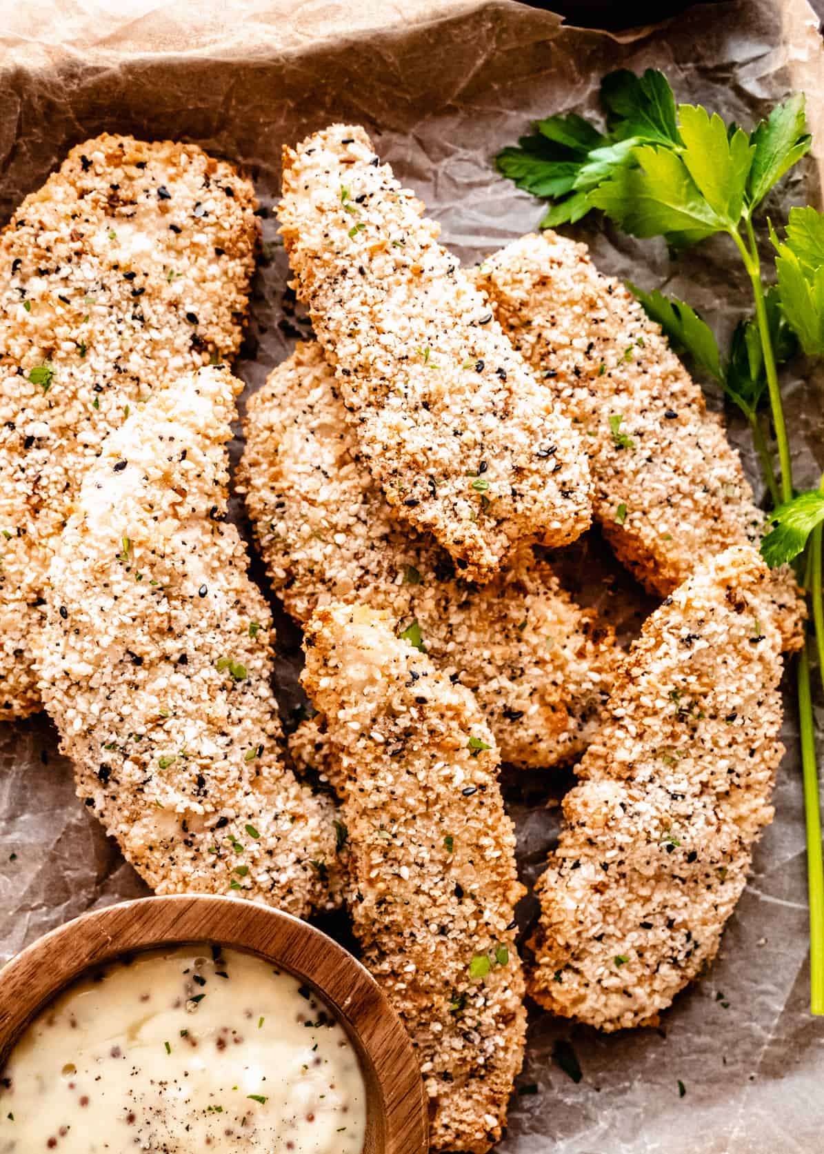 A plate of delicious chicken tenders, perfectly cooked and served with a mouthwatering sauce.