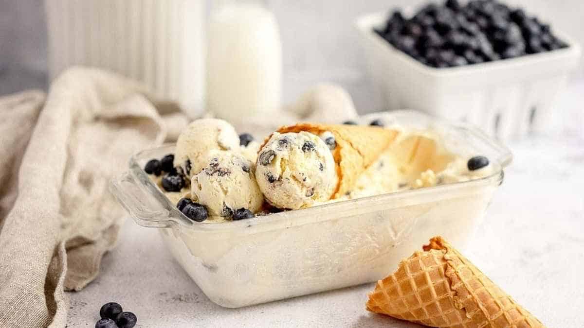Blueberry ice cream in a glass container.