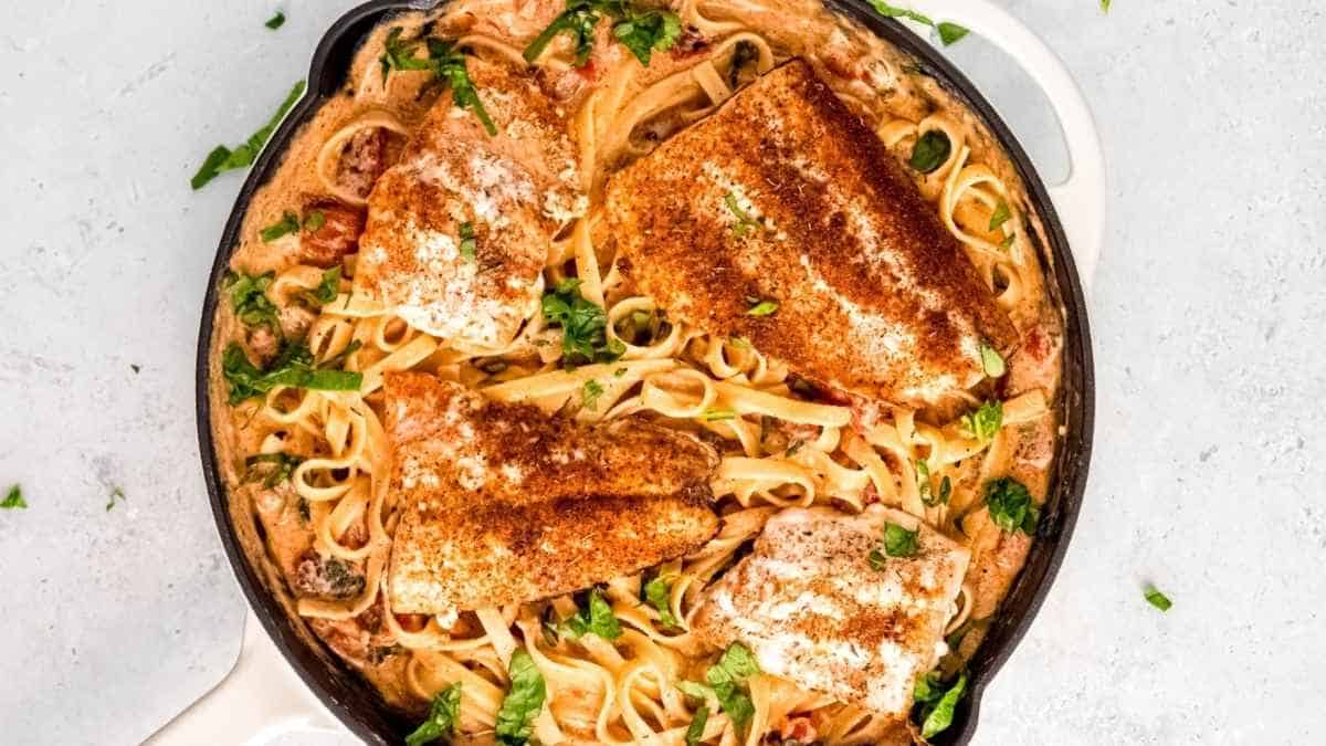 A skillet filled with pasta and chicken.