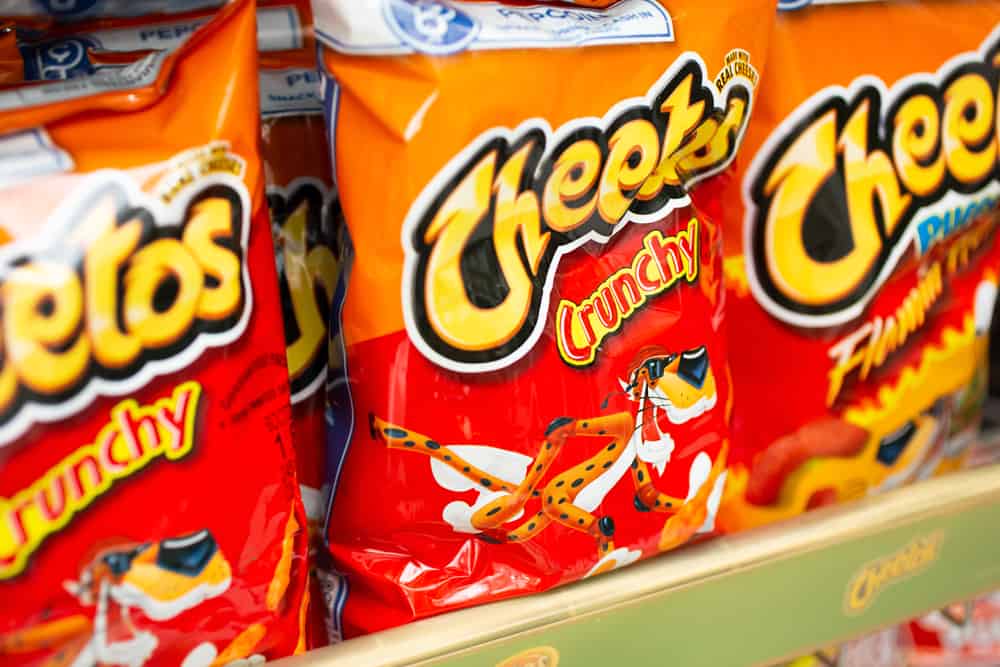 Cheetos chips on a shelf in a store.