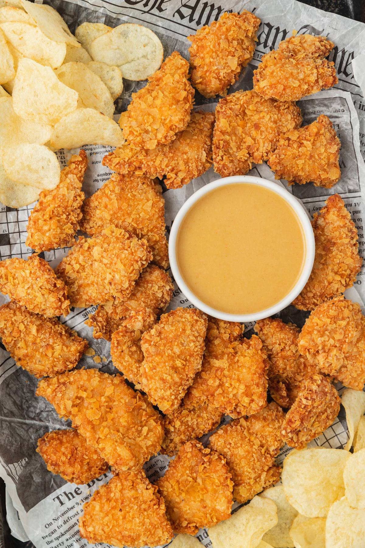 Chicken tender recipes featuring fried chicken nuggets with a side of potato chips and dipping sauce.