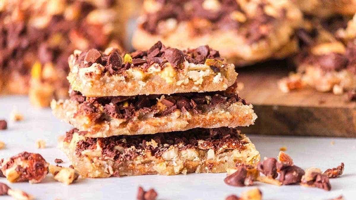 A stack of chocolate peanut butter bars on a cutting board.