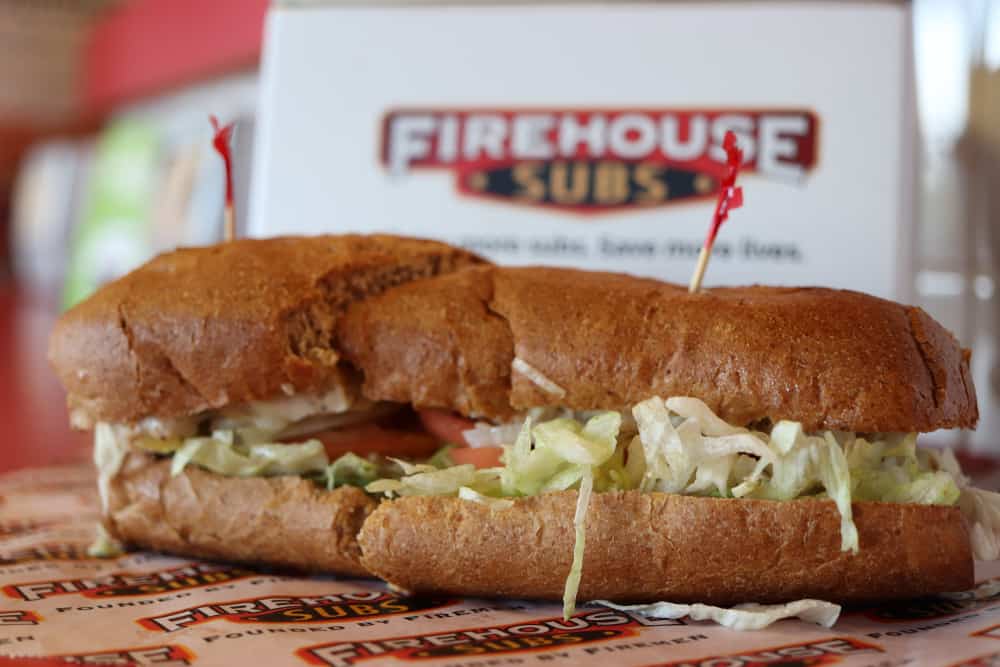 A firehouse sub sandwich on a gluten-free paper plate.