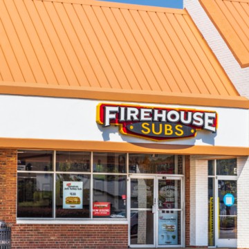 A firehouse subs store on the corner of a street, offering delicious and gluten-free sandwich options.