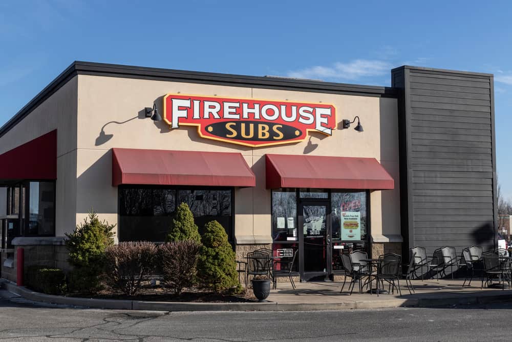 A firehouse subs restaurant on the corner of a street, offering gluten-free options.