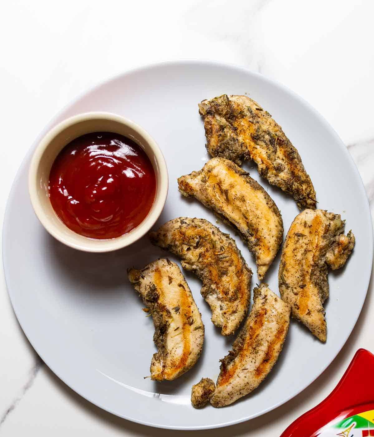        Description: Chicken wings with ketchup on a plate. This delectable dish features chicken wings cooked to perfection and topped with savory ketchup. Whether you're looking for chicken tender recipes or simply