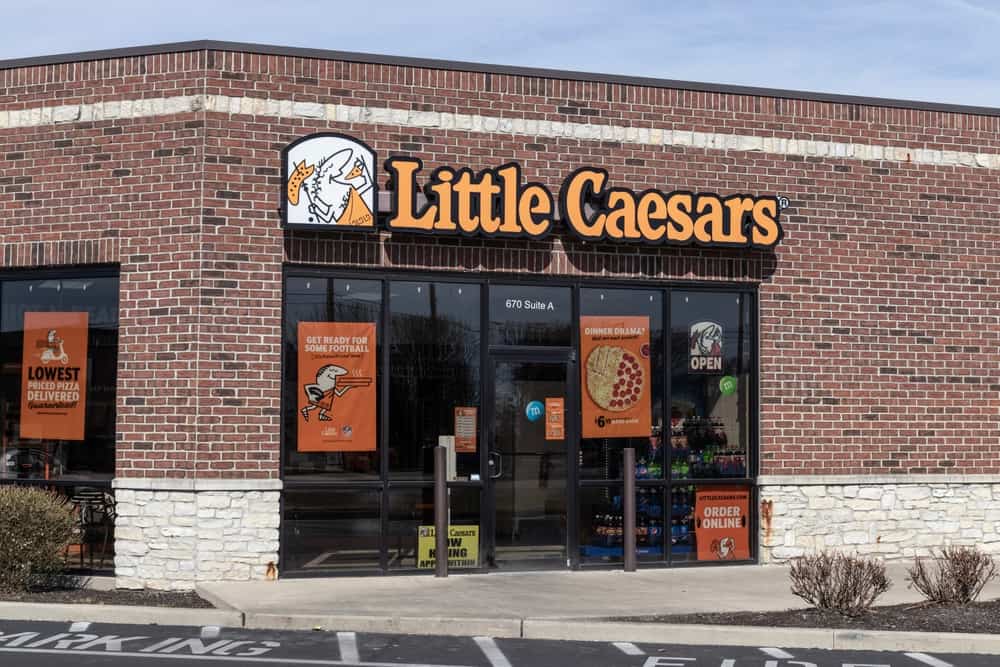 The front of a Little Caesars store, featuring the Little Caesars Gluten Free Menu.