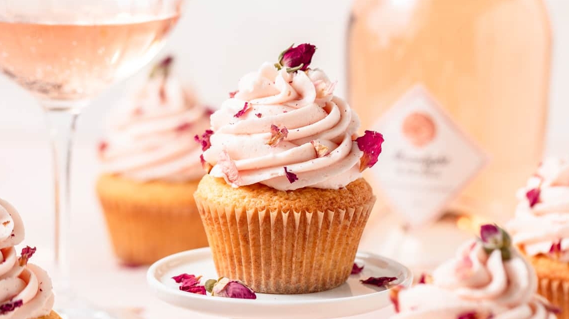 Cupcakes with roses and a bottle of wine.