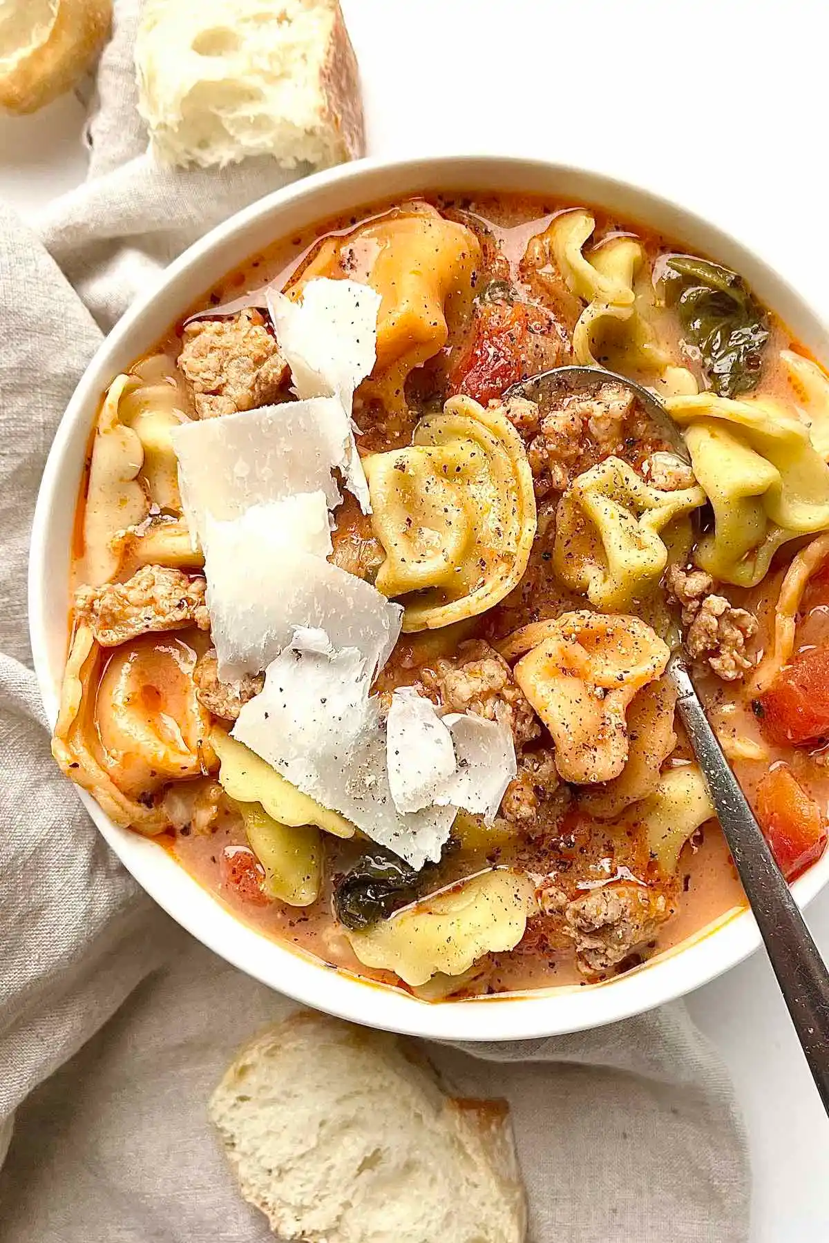 A bowl of soup with ground sausage.