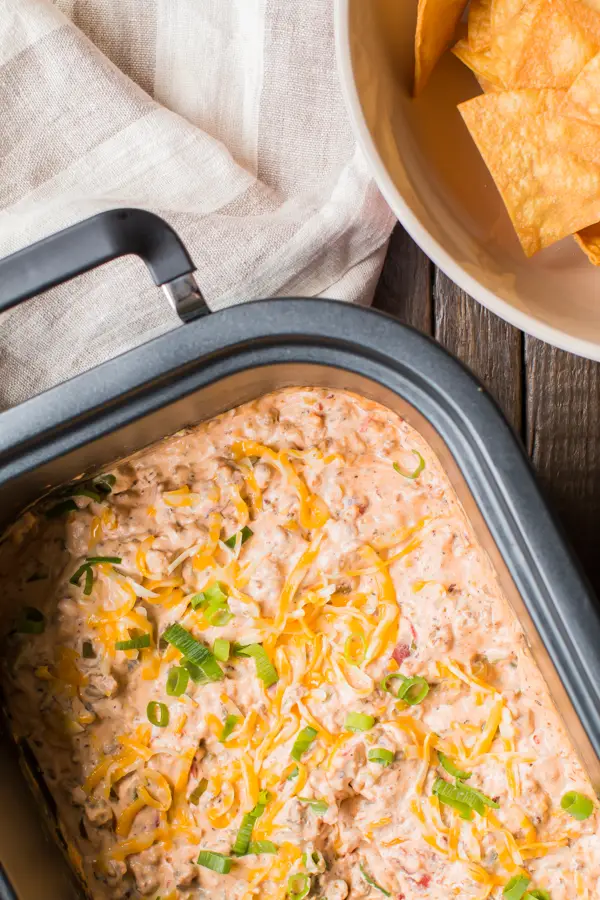 Cheesy chicken dip with tortilla chips, perfect for parties or game nights.