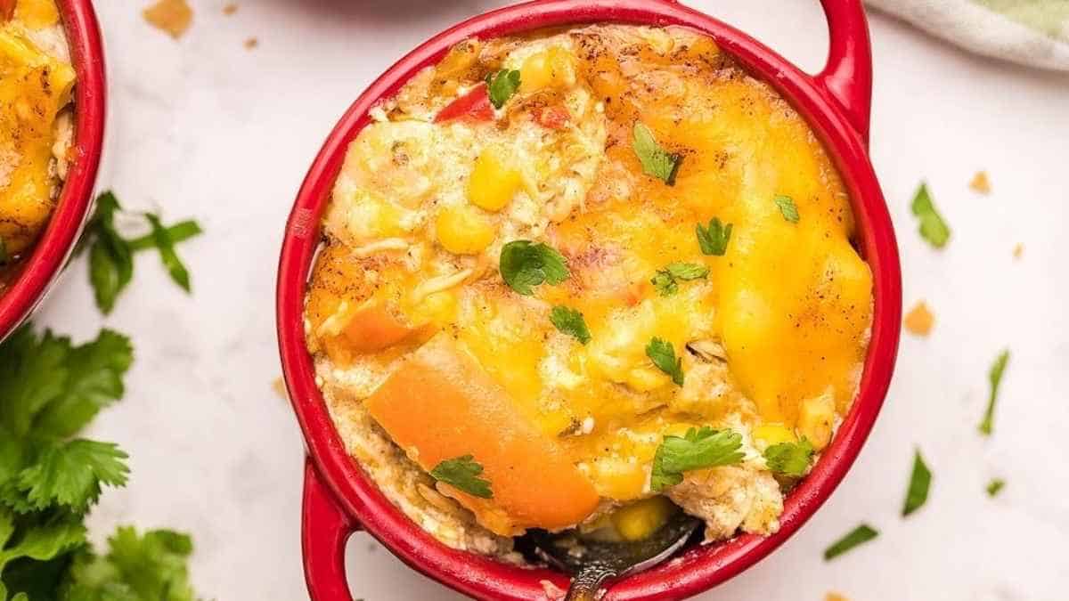 Chicken and corn casserole in a red dish.