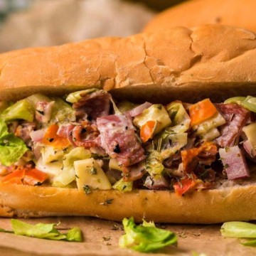 A sandwich with meat and vegetables.