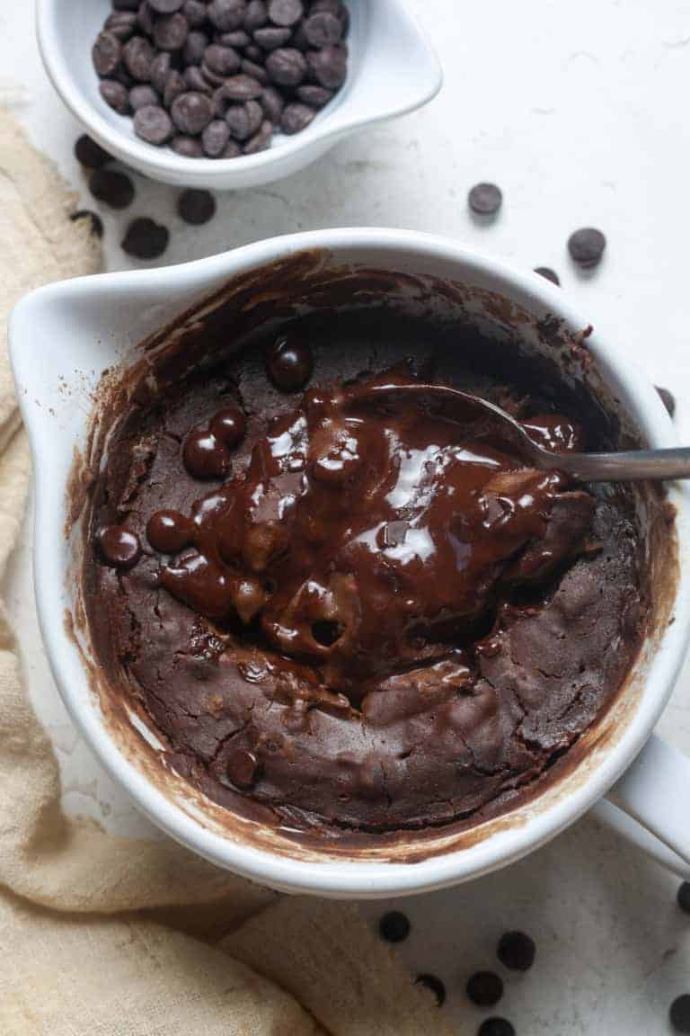 High protein chocolate pudding in a white bowl with chocolate chips.