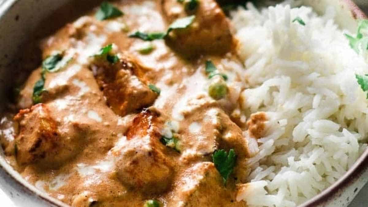 Chicken tikka masala in a bowl with rice.