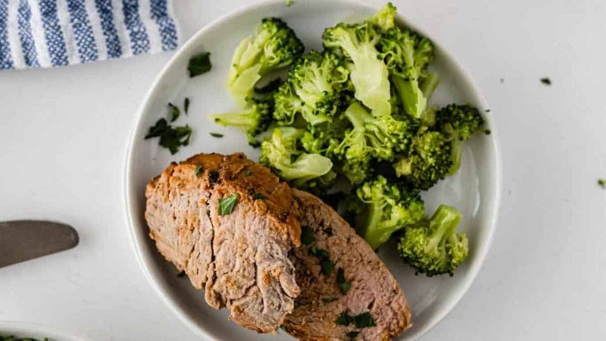 A plate of meat and broccoli.