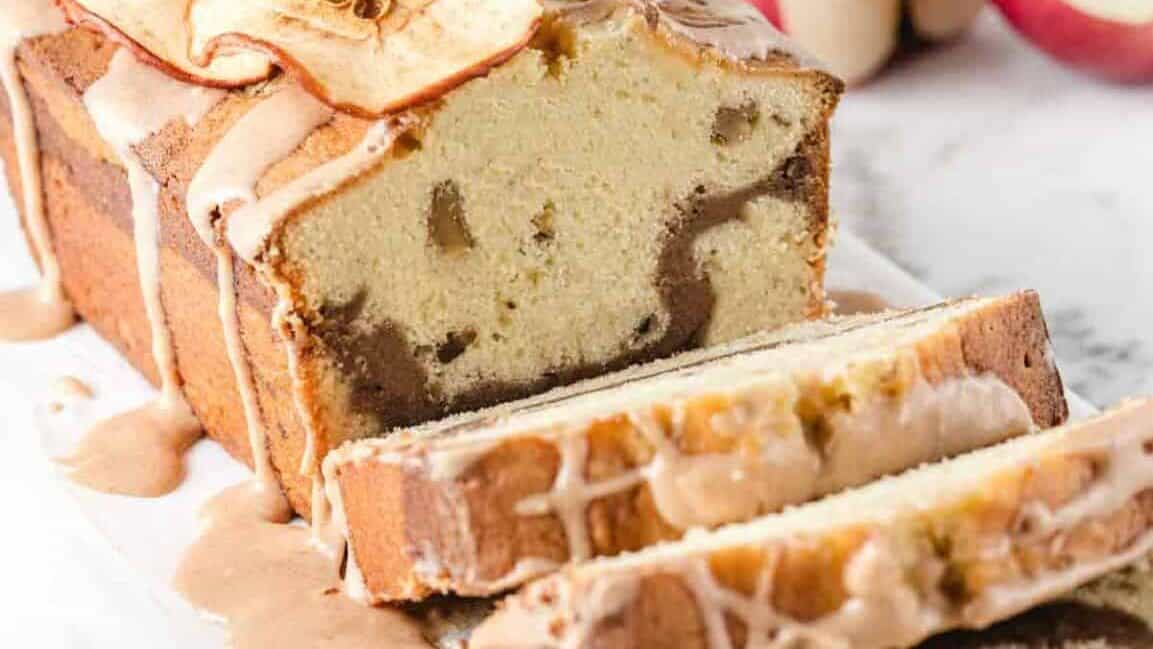 A slice of apple bread on a white plate.