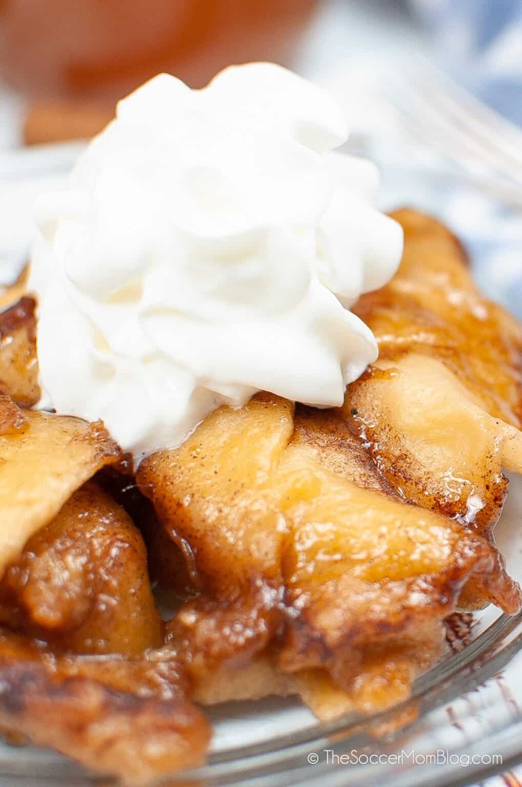 Instant Pot Apple Dumplings with whipped cream topping.
