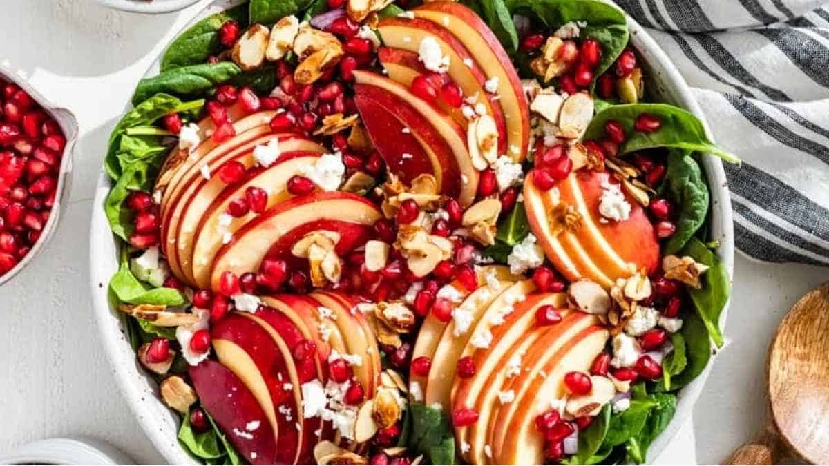 A salad with apples, pomegranate and walnuts.