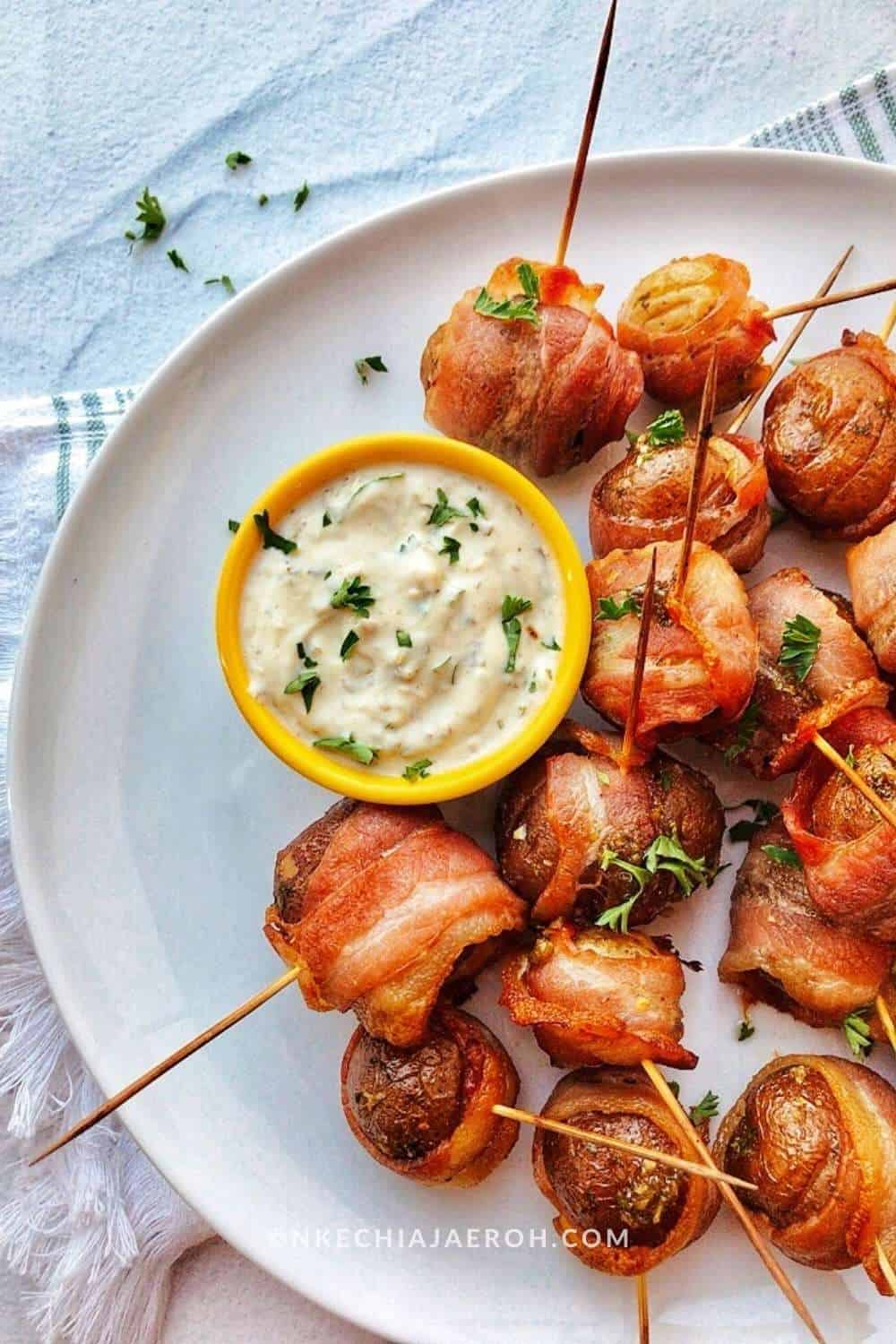 Small potatoes marinated in coconut cream parsley pesto wrapped in bacon and baked to perfection is literal heaven. These bacon wrapped small potatoes are tasty, flavorful, tender and soft inside, perfectly toasted, and crisp outside. Whether you are looking for your family’s next best appetizer, or you are looking for that perfect dish to bring to the next potluck, these babies fit just right because they would please everyone! 
