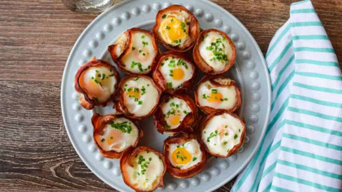 Bacon wrapped eggs on a plate.