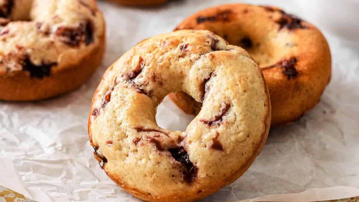 Chocolate chip donuts on a baking sheet.