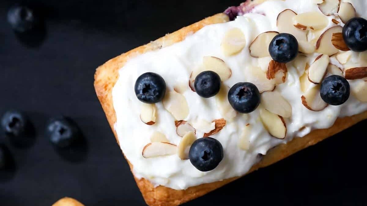 Blueberry almond scones with whipped cream and almonds.