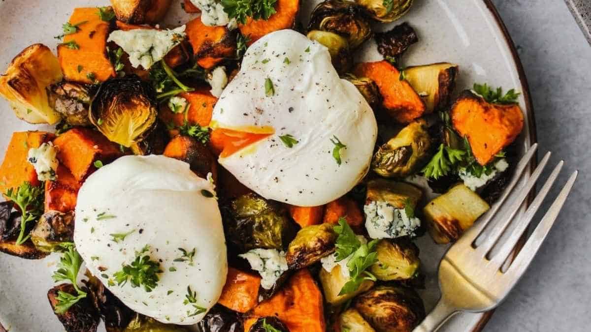 Roasted brussels sprouts with poached egg on a plate.