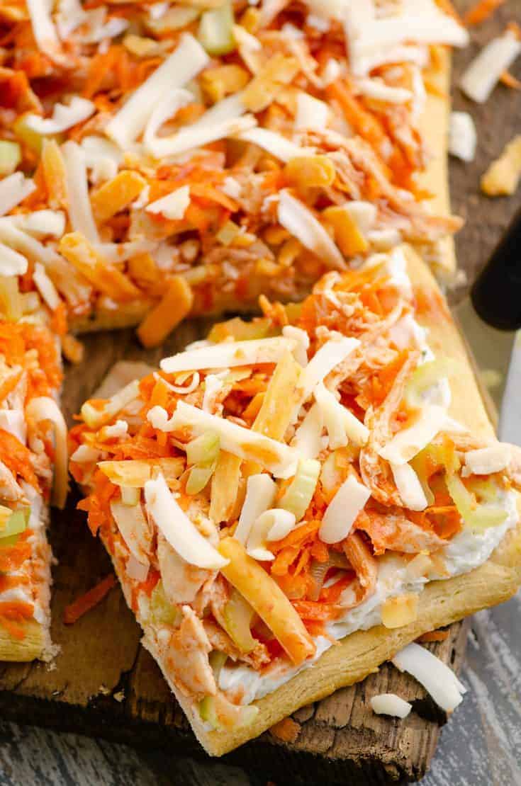 Buffalo Chicken Vegetable Pizza slice cut out on wood table.
