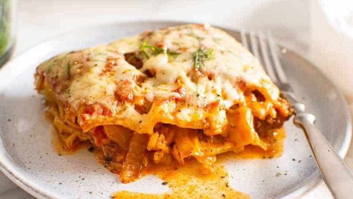 A plate of lasagna on a white plate.