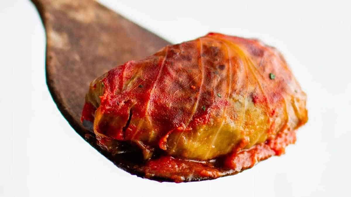 Stuffed cabbage on a wooden spoon.