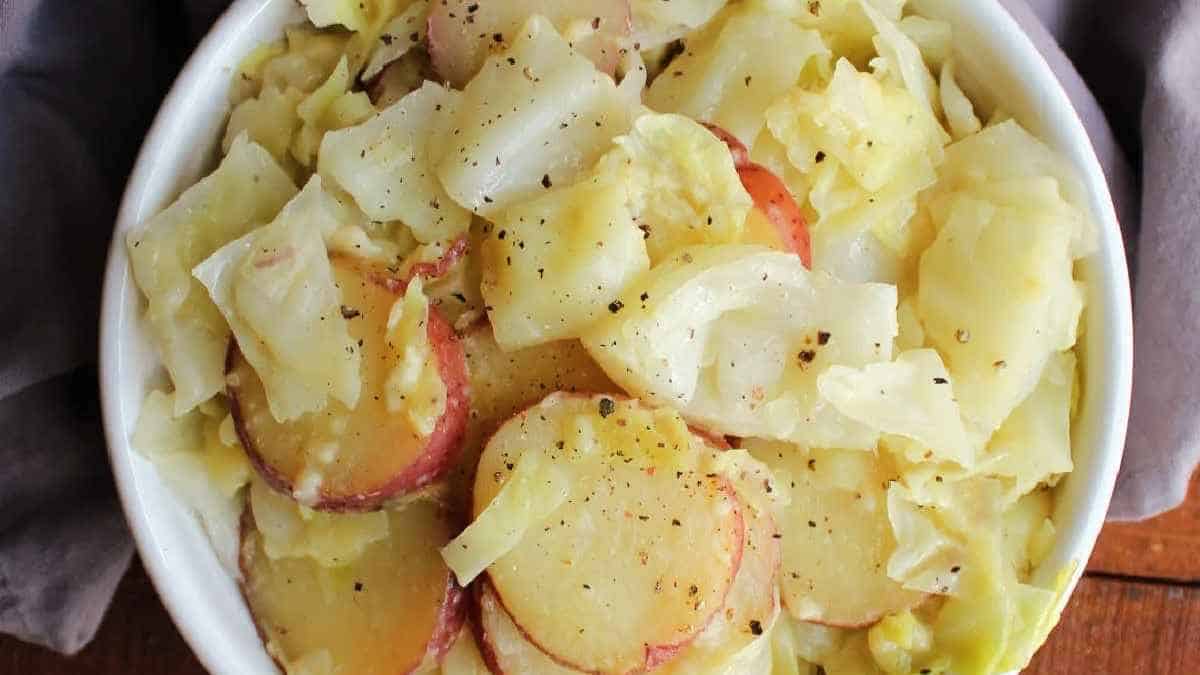 Cabbage and potatoes in a white bowl.