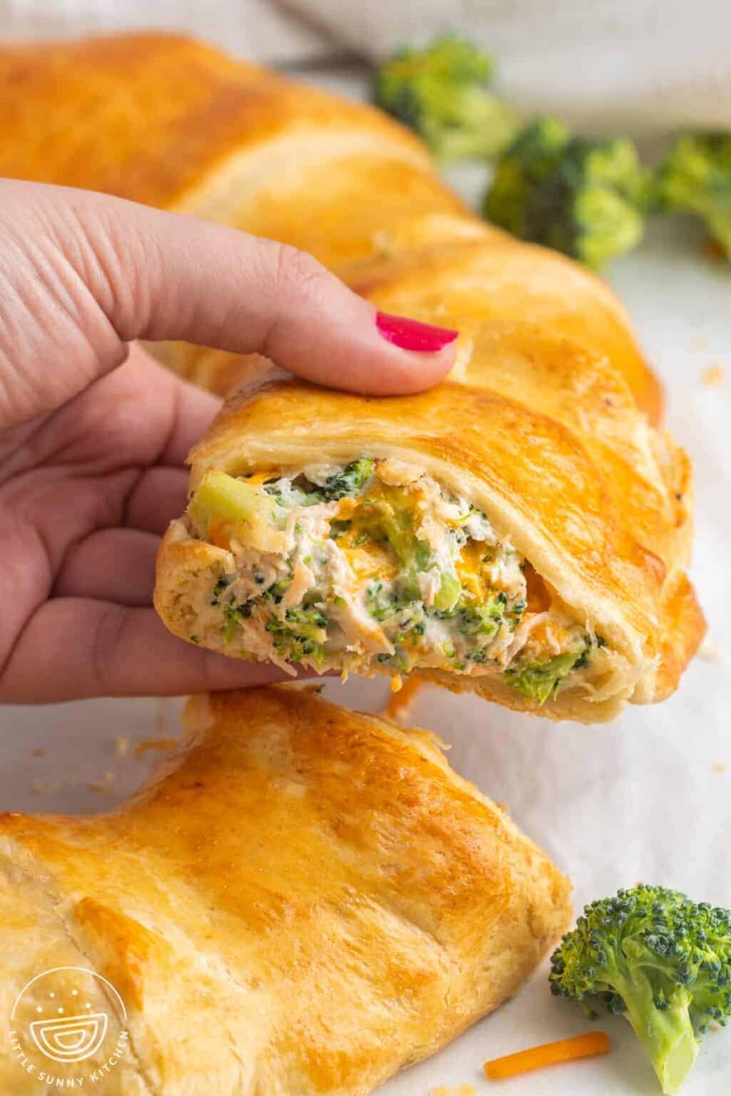 Taking a cheesy chicken and broccoli crescent slice off a larger ring.
