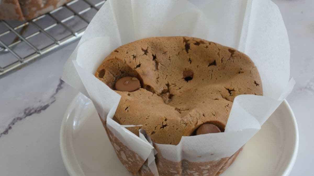 A chocolate muffin sitting on top of a plate.
