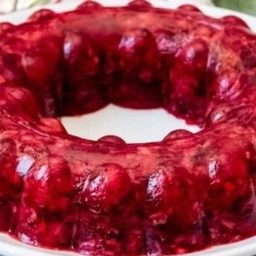 A plate of jello with red jello inside.
