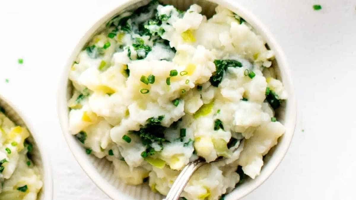 Two bowls of mashed potatoes with spinach.