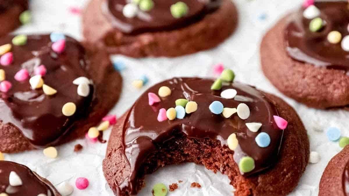 Chocolate cookies with a bite taken out of them.