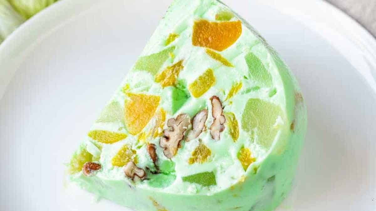 A slice of green ice cream on a plate.