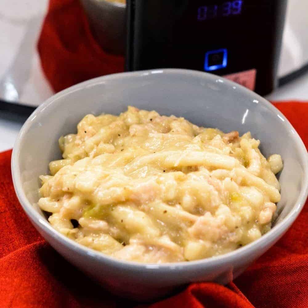 Easy Crock Pot Chicken and Noodles is made by slow cooking chicken, onions, celery, and garlic all day and then adding Reames wide noodles. 
