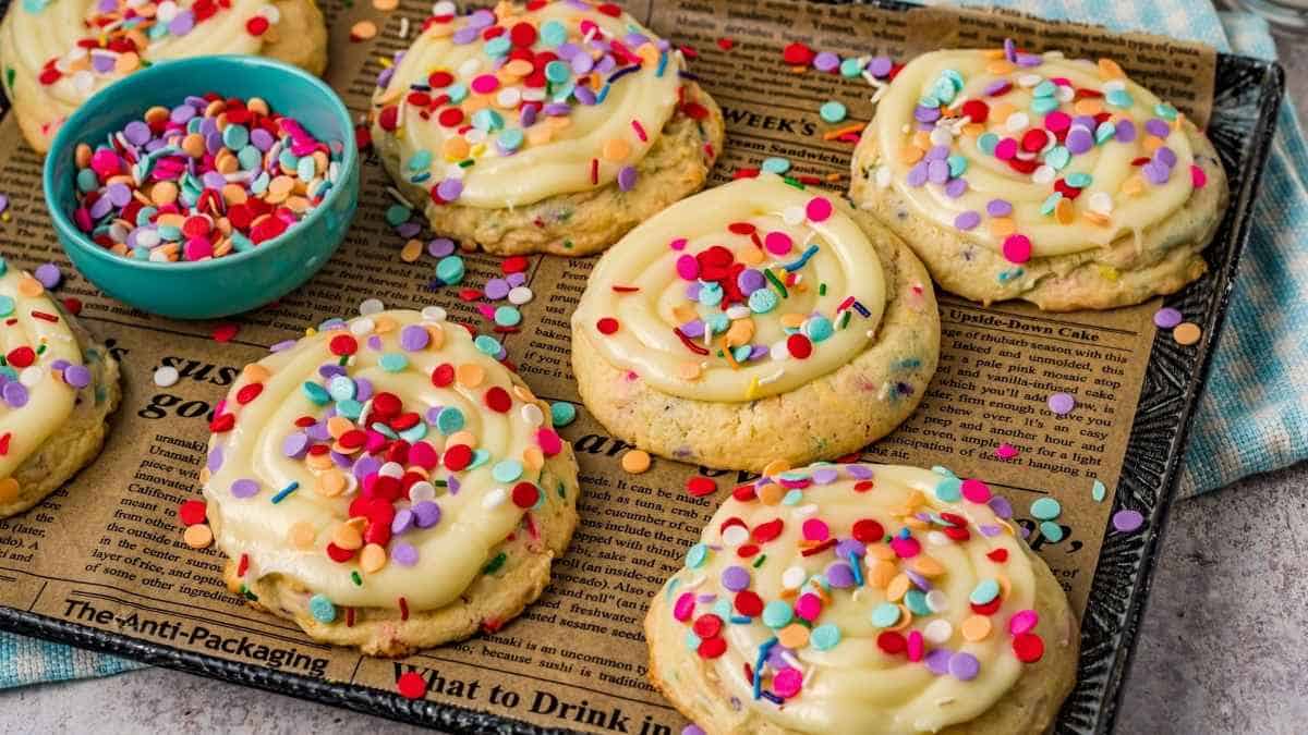 A tray of cookies with sprinkles and icing.