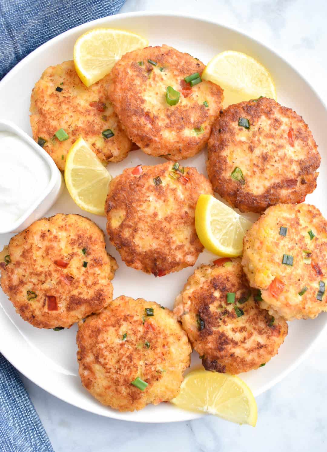Plate of Easy Shrimp Cakes with lemon wedges.
