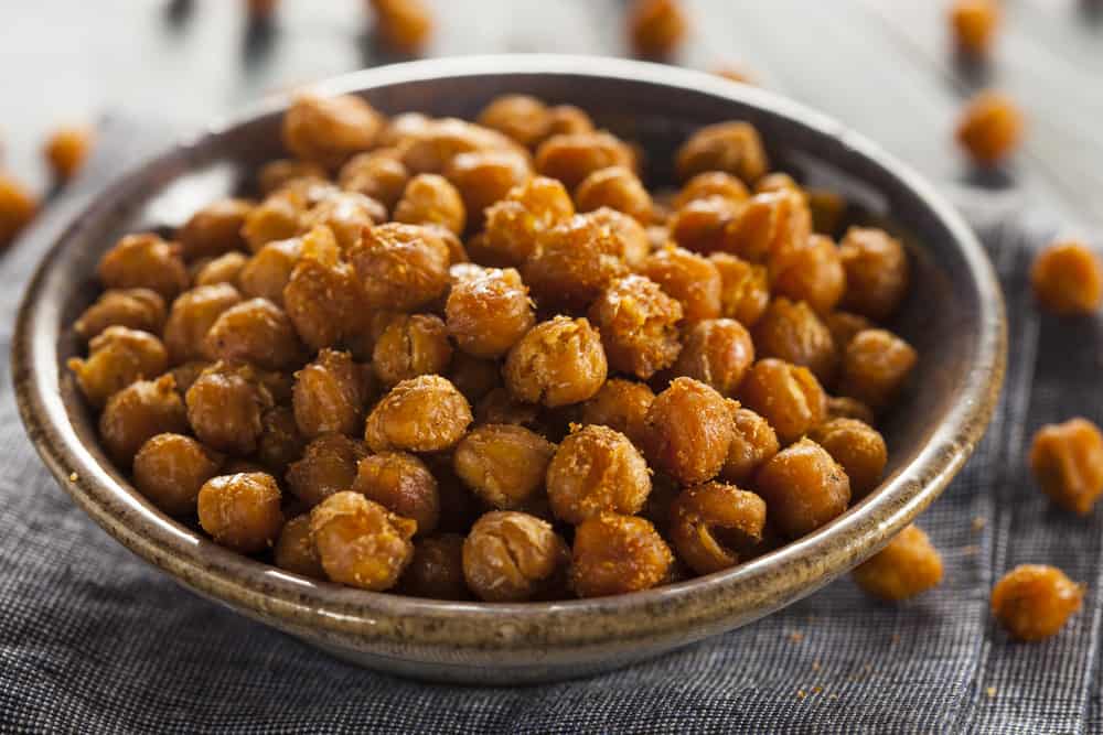 Roasted chickpeas in a bowl on a table.