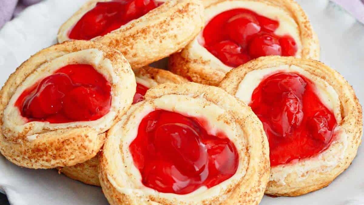 A plate of pastries with cherry filling.