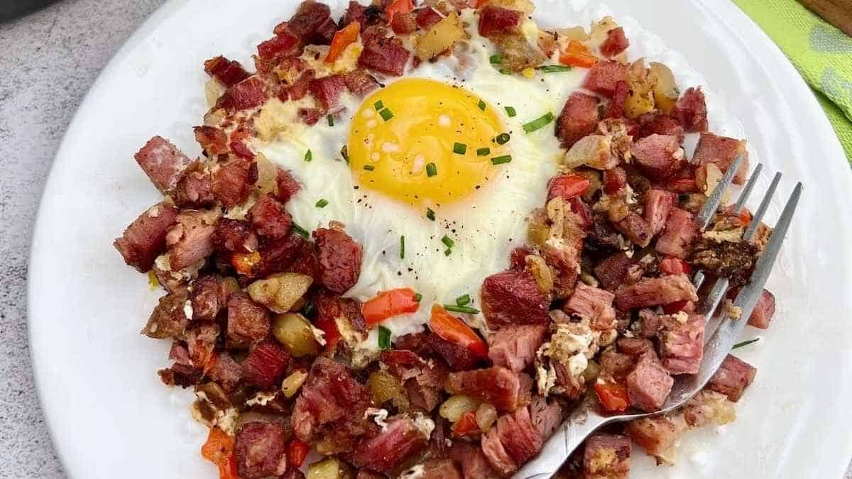 A plate with a fried egg and meat on it.