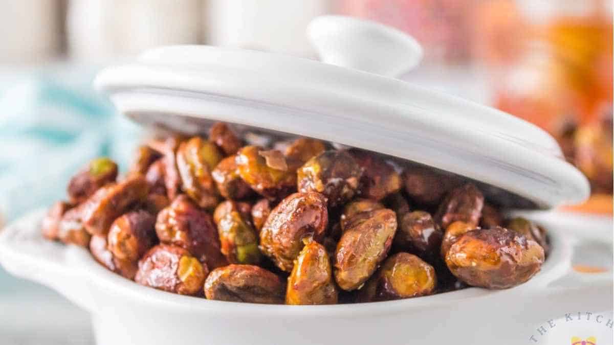 Roasted pistachios in a white bowl.