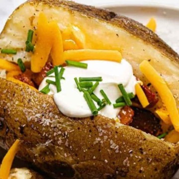 Baked potatoes topped with cheese and sour cream.