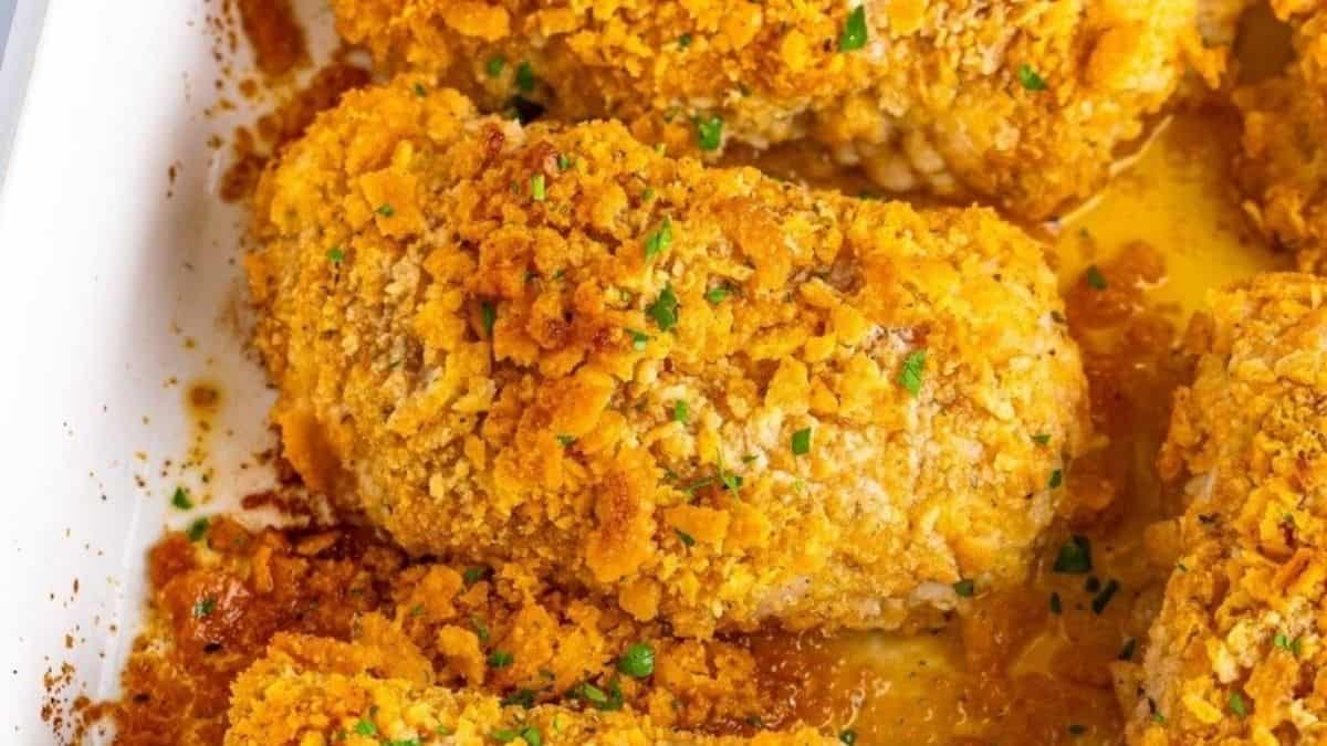 Fried chicken breasts in a white baking dish.