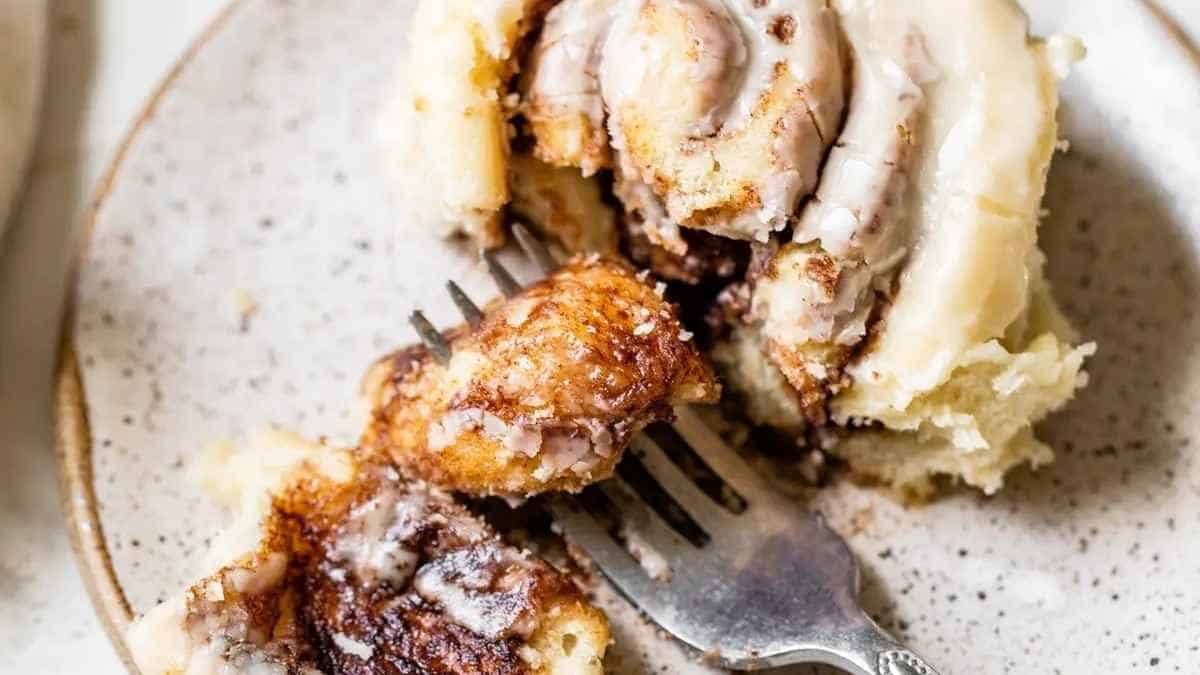 Cinnamon rolls on a plate with a fork.