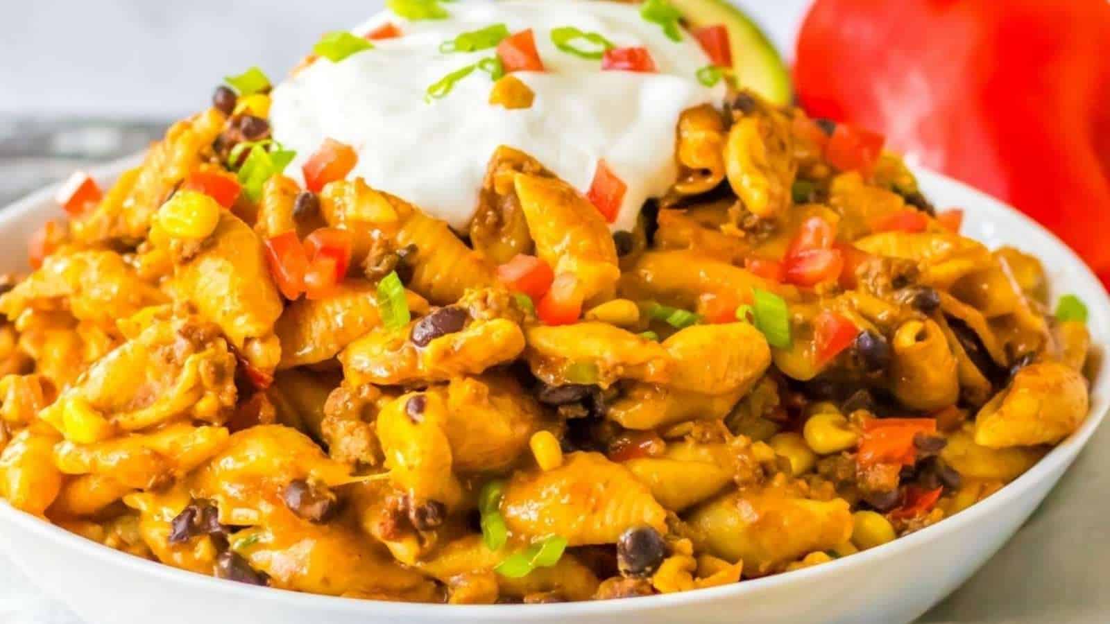 Mexican chicken pasta in a bowl with sour cream.