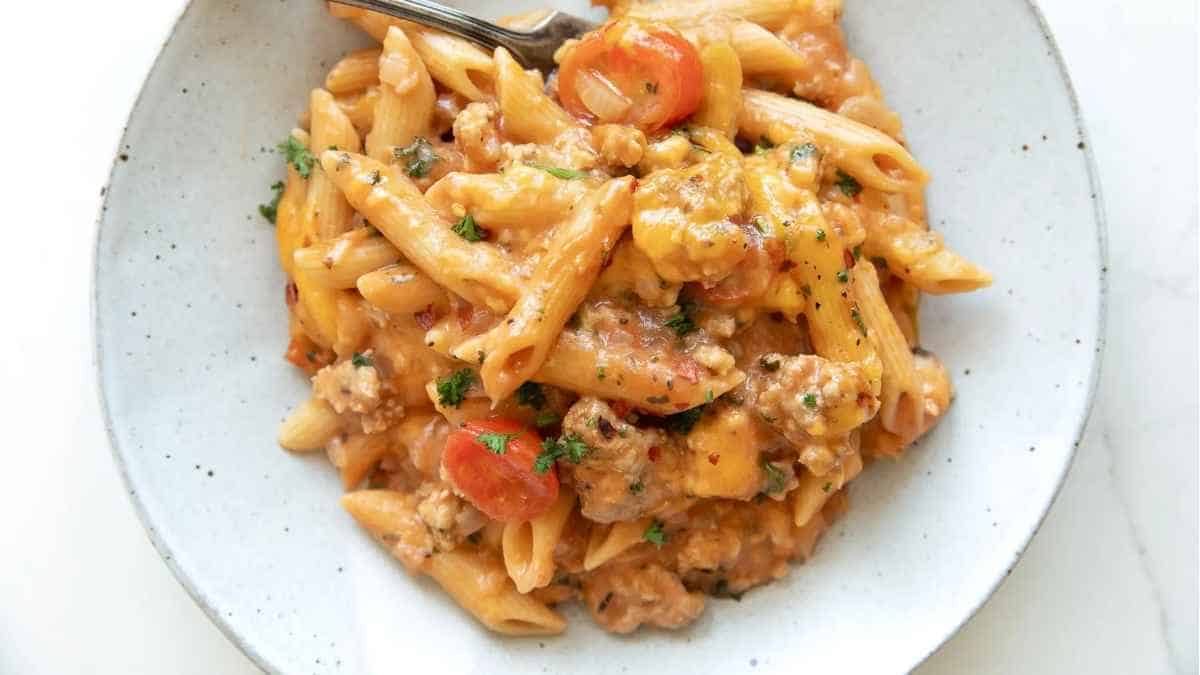 A plate of pasta with meat sauce and tomatoes.